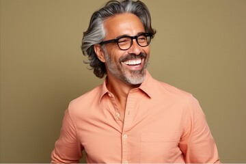 Portrait of a handsome middle-aged man with grey hair wearing glasses.
