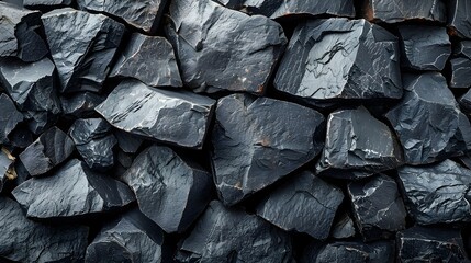 Pile of Black Rocks on a Wall, To provide a unique and visually striking background for design projects, or to showcase the natural beauty and