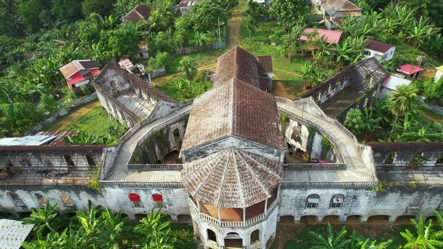 Aerial view rising in front of the Old Hospital in Ro&ccedil;a Agua Iz&eacute;, sunny Sao Tome