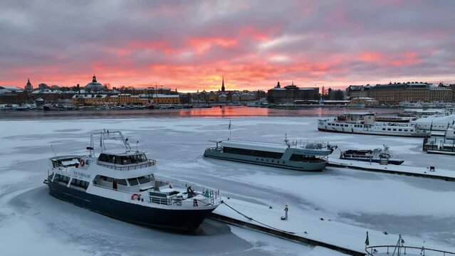 Vibrant Sunset Over Frozen Ladug&aring;rdslandsviken: Central Stockholm Drone Flight