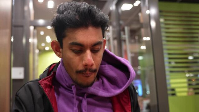 Close up portrait of Sri Lankan man eating fast food fries wear casual clothing