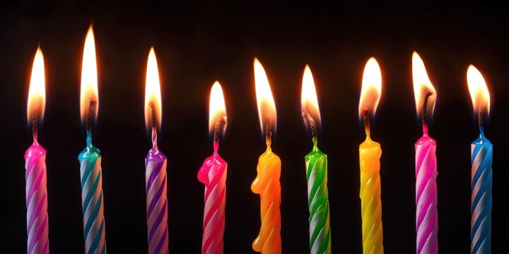 Colorful candle in dark background, burning candles on a black background, birthday candles