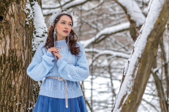 Princess Snow White in the winter forest. Fairy-tale character in bright outfits. A sweet and modern story with emotions.