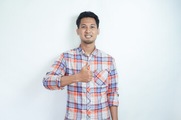 Fototapeta premium Adult Asian man smiling and give thumb up at camera