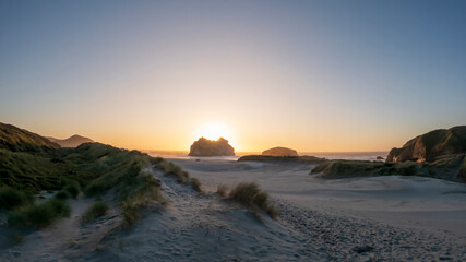 Golden Hour Serenity: Sunset Landscape Overlooking Wharariki Beach and the Tasman Sea, South Island, New Zealand