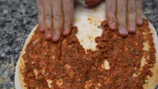 Chef of bakery making a Turkish pizza or lahmacun 4K