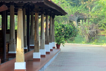 Ancient architecture. the entrance with stone pillers and wooden ceiling. Side of the image...