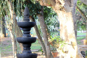 Multi level Deep mala made of single black stone in middle of the garden with various fruites and...