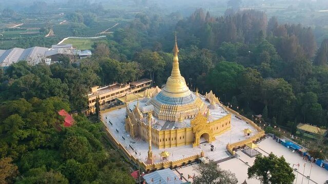 Aerial of Buddhist temple with golden pagoda in Lumbini Natural Park or Taman Alam Lumbini in Desa Dolat Rayat, Berastagi in North Sumatra, Indonesia.