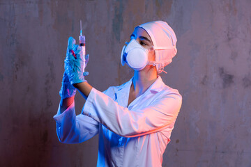 A woman in white lab coat holding syringe