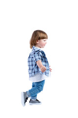 Smiling little boy 2 years old runs. Child wearing a blue checkered shirt and a white T-shirt. Activity, energy and childlike spontaneity. Full height. Side view. Isolated on a white background. 