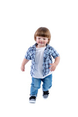 Smiling little boy 2 years old runs. Child wearing a blue checkered shirt and a white T-shirt. Activity, energy and childlike spontaneity. Full height. Isolated on a white background. Vertical.
