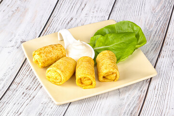 Stuffed pancakes with cream sauce