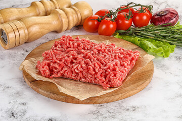 Raw minced beef meat on cutting board