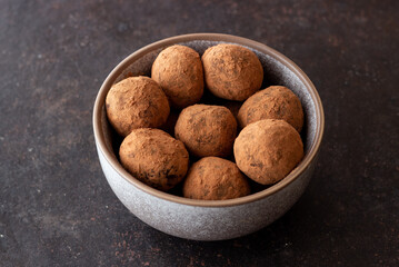 Chocolate truffle candies sprinkled with cocoa. Dessert. Vegetarian food.
