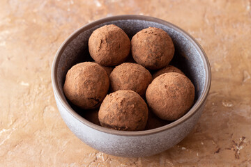Chocolate truffle candies sprinkled with cocoa. Dessert. Vegetarian food.