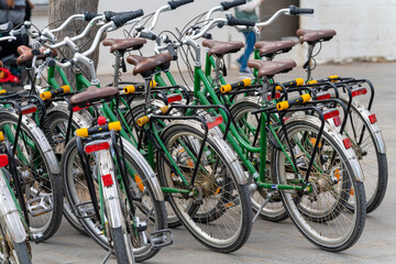 Many rental bicycles are parked on the streets of Barcelona. Urban carbon-free city transport...