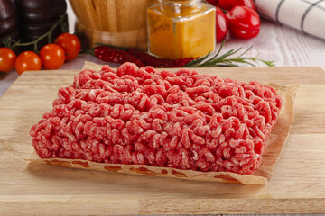 Raw minced beef meat over board