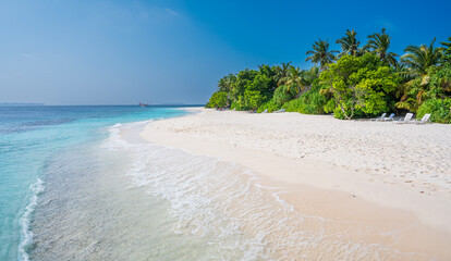 Beautiful sandy beach with a dense green forest. Seaplane floats on the sea.