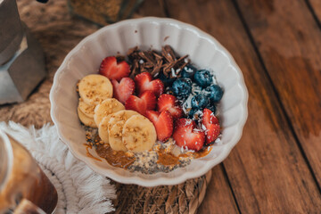 Oatmeal topped with fruit Chocolate and bee pollen