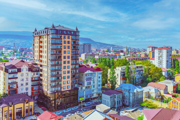 View of the city of Makhachkala in the Republic of Dagestan against a background of blue sky and morning fog. Trip, travel on vacation. Cityscape. - obrazy, fototapety, plakaty