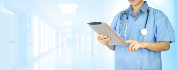 Doctor working on a digital tablet hospital white spec background