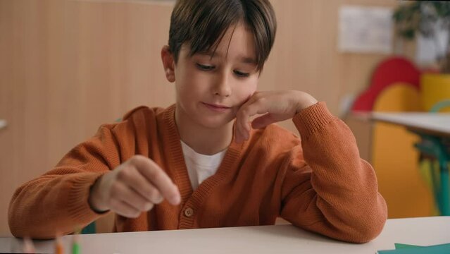 Little school boy primary schoolboy Caucasian son kid child clever smart writing task exercise at class lesson tired failure problem irritated trouble education difficulty hard studying learning study