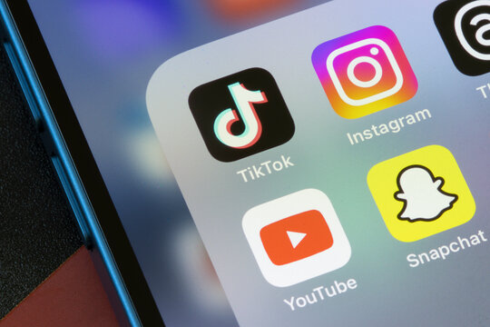 Portland, OR, USA - Mar 7, 2024: TikTok, Instagram, YouTube, and Snapchat app icons are seen on an iPhone. TikTok vs Instagram Reels vs YouTube Shorts vs Snap Spotlight concepts.