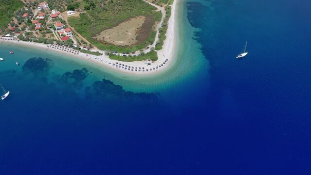 Aerial: Backwards reveal shot of Agios Dimitrios amazing sandy and crystal clear beach in Alonnisos island, Greece