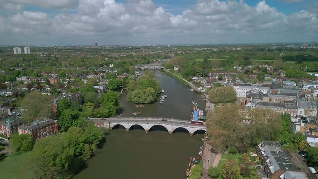 The drone aerial footage of Thames River runs through Richmond town centre on the east bank with its neighbouring district of East Twickenham to the west, London, UK.