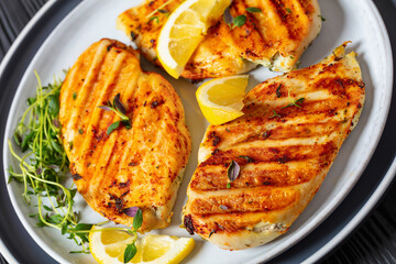 juicy grilled chicken cutlets on plate, top view