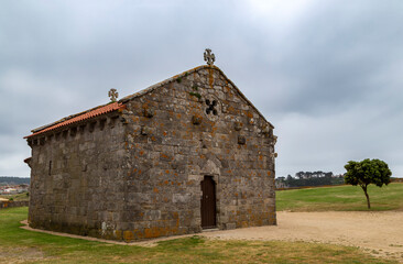 Fototapeta na wymiar Romanesque hermitage of Nuestra Señora de La Lanzada from the beginning of the 13th century. Noalla, Galicia, Spain.