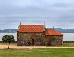 Fototapeta na wymiar Romanesque hermitage of Nuestra Señora de La Lanzada from the beginning of the 13th century. Noalla, Galicia, Spain.