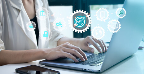 Close-Up of Businesswoman using computer laptop with dartboard for setup business objective target and goal concept