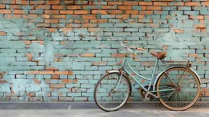 Fototapeten An antique bicycle by the side of the road with an old brick wall backdrop © tongpatong