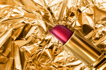 Red lipstick on golden foil