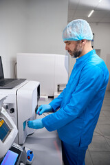 Specialist works on apparatus for automatic extraction of nucleic acids