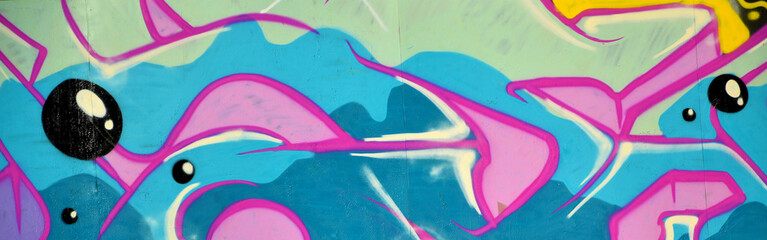 Colorful background of graffiti painting artwork with bright aerosol outlines on wall. Old school...