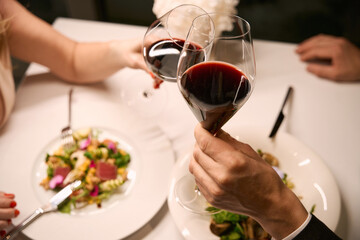 Couple drinking red wine at dinner in restaurant