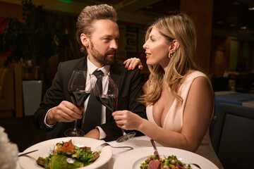 Couple enjoying a romantic dinner in a cozy restaurant