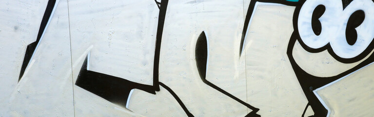 Colorful background of graffiti painting artwork with bright aerosol outlines on wall. Old school...