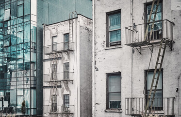 Old buildings with fire escapes, color toning applied, New York City, USA. - 753514150