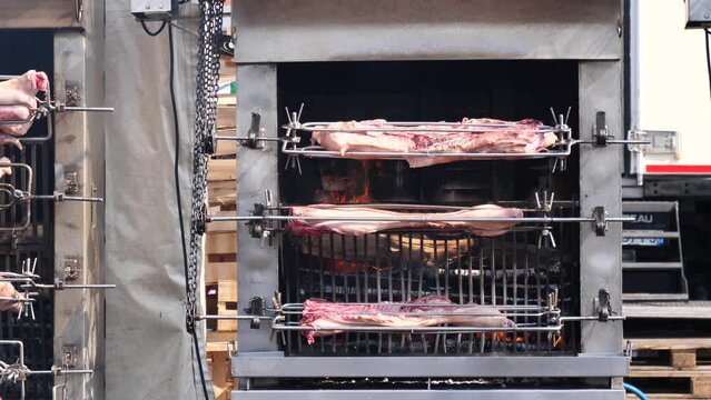 Suckling pig on the rotisserie on the open fire