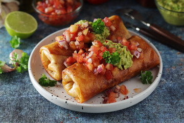 A typical dish of Mexican cuisine - Chimichanga, made of tortilla with different ingredients