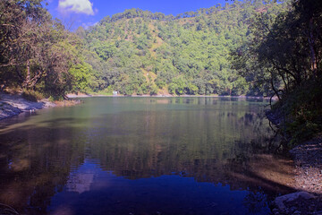 One of the small forested freshwater lakes that make up the Sattal, in the Nainital district, Uttarakhand, India,