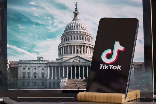 TikTok sign is sharp in the foreground, while American Congress building is blurred in the background, concept for Tik Tok ban in the United States,  USA, March 8, 2024