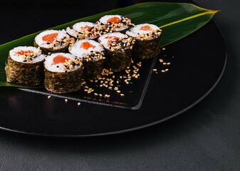 Sushi Rolls Set with Salmon on black plate