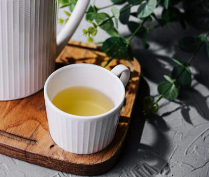 Japanese green tea in white cup and teapot