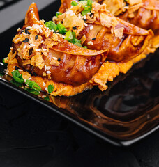 Fried dumplings Gyoza on black plate