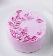 Piece of chocolate cake with pink cream top view